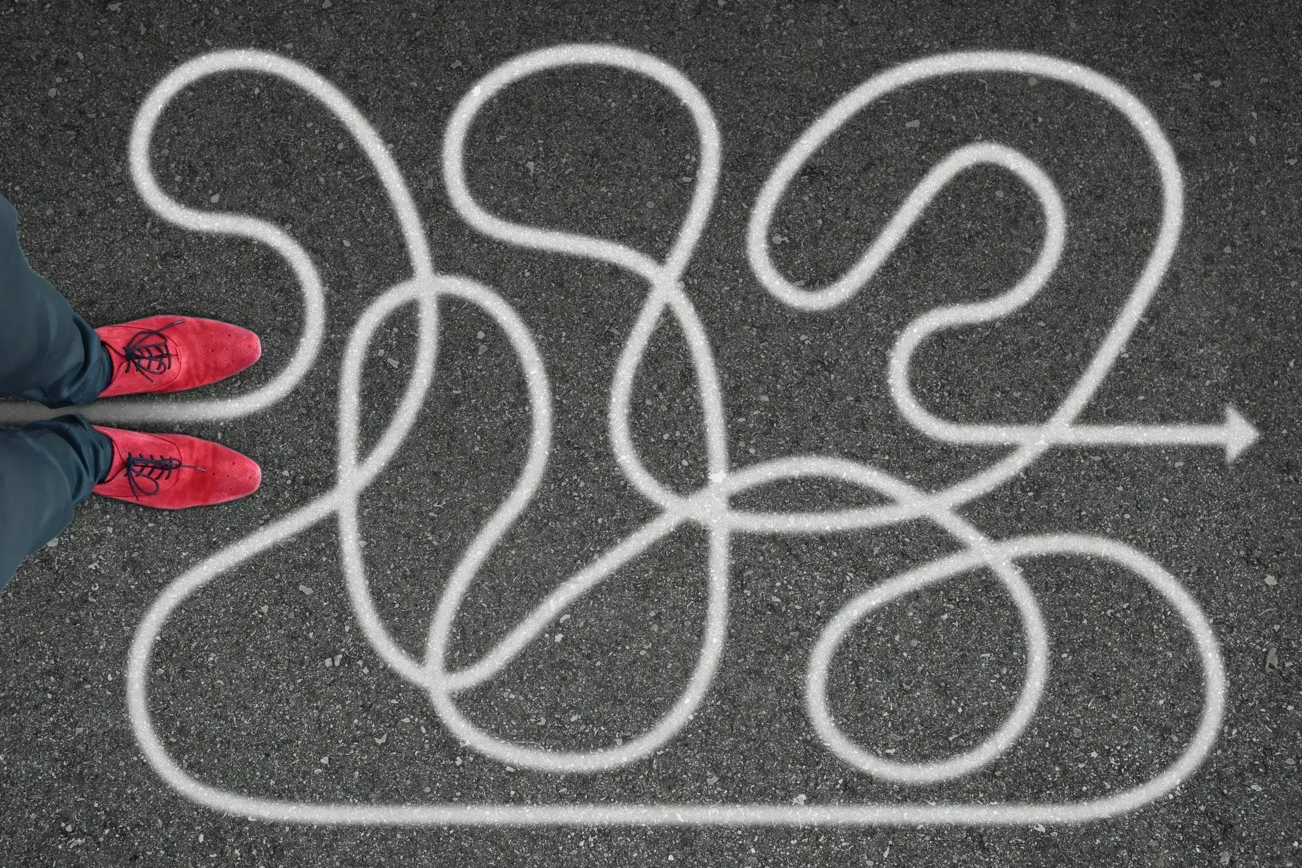 Red shoes facing a complex path drawing.